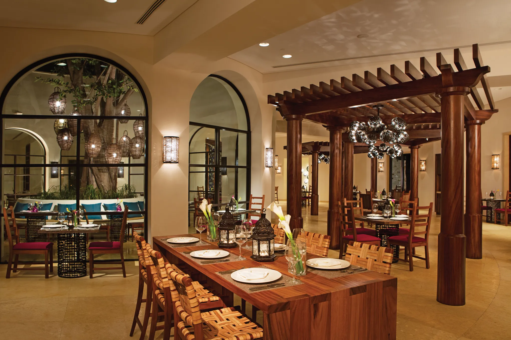 El Patio Mexican Restaurant at Secrets Akumal Riviera Maya featuring warm traditional décor, wood pergola seating, and an inviting old-world dining ambiance.
