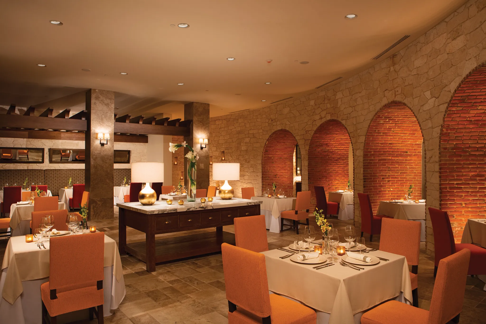 Portofino Italian Restaurant at Secrets Akumal Riviera Maya featuring elegant indoor dining with Tuscan-inspired décor, warm lighting, and white tablecloth tables.