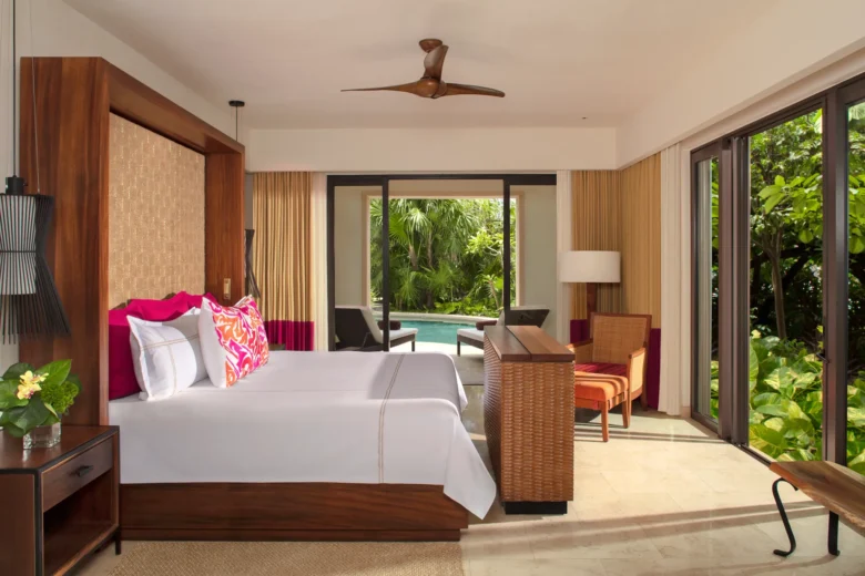 Romance Master Suite Swim Out bedroom with king bed and terrace access at Secrets Akumal Riviera Maya.