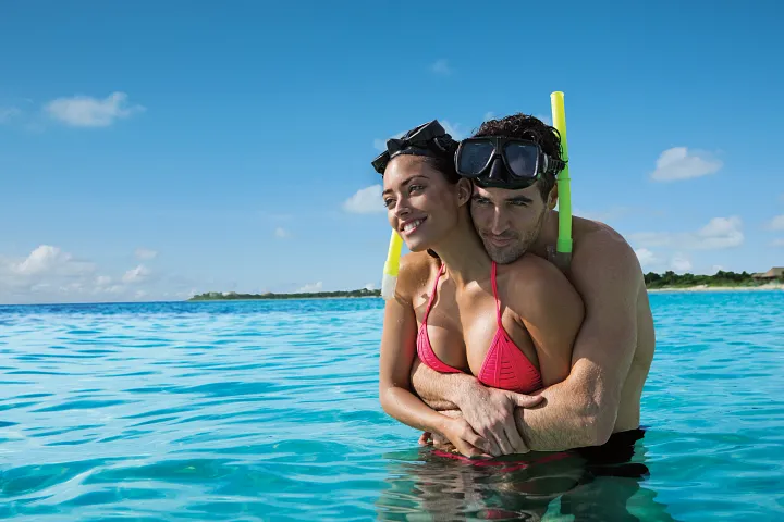 secrets-akumal-couple-snorkeling-turquoise-water
